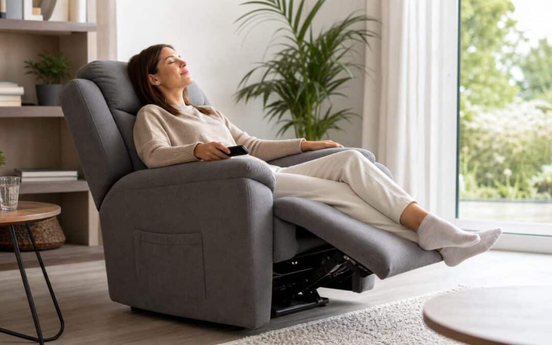 Woman relaxing in a grey motorized recliner chair with her eyes closed, holding a remote control in a bright, modern living room.